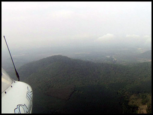 A range of hills pass below the aircraft.