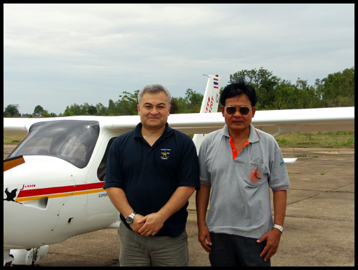 Noel Jackson and Doctor Chern Bramacupta stand together besides the Jabiru.