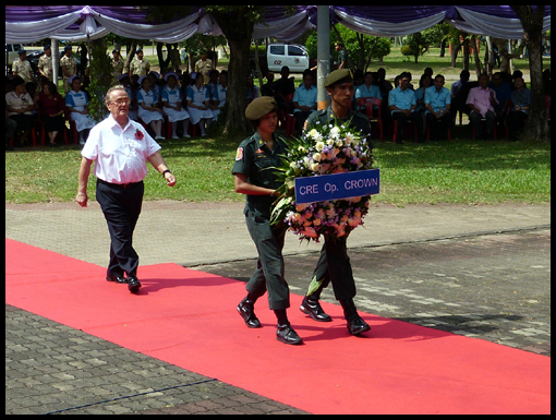 Bill Edwards bows in respect to the Operatiom Crown wreath.