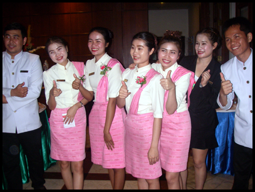 The Maitre D and staff of the Laithong hotel. Note the noticeboard incoorecr spelling.