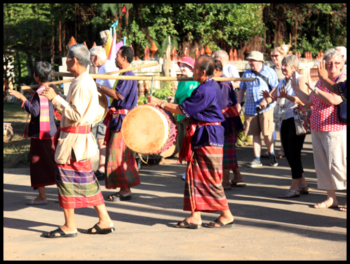 The OCA party dances into the square encouraged by the villagers.