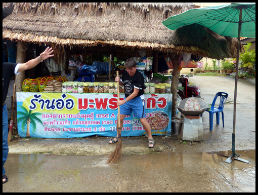 Neville with the Devil rampant within him sweeps flood water from the market place.