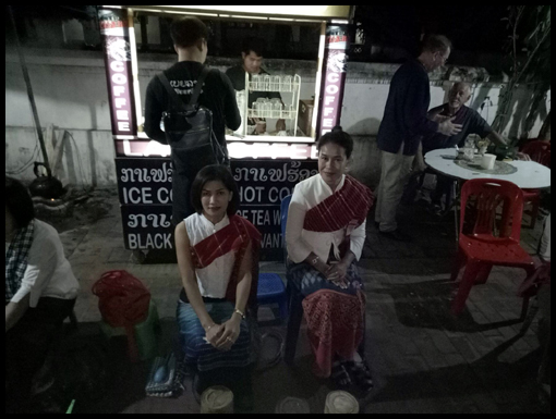 The worshippers take their saibaht positions on the street.