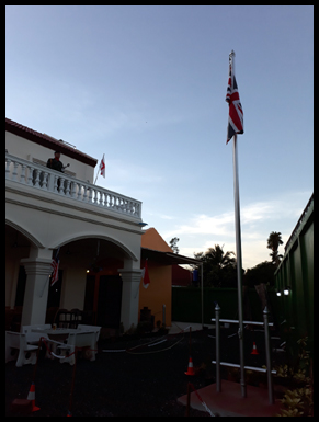 A Bugler stands on the balcony waiting for sunset.