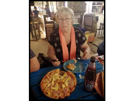 Gill eats a delicious pizza at the Food Box Mukdahan.