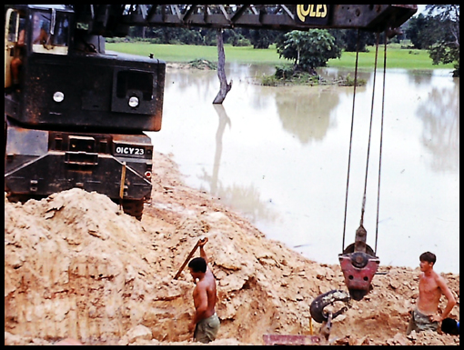 Sappers working waist deep in monsoon waters.