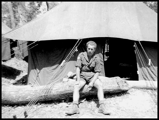 Cpl George Brown sits outside his abode in the tented camp.