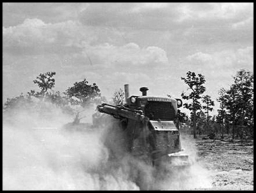 The Dozer operator cannot be seen as he's enveloped by a dust cloud.