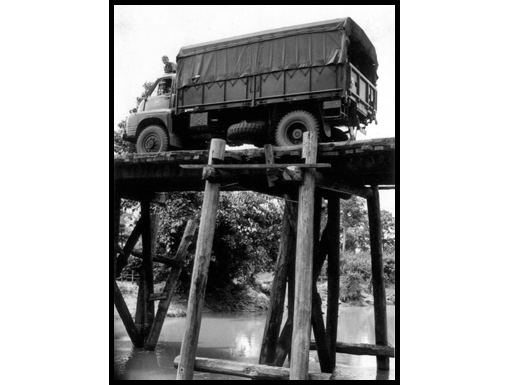 A Bedford RL negotiates a high wooden bridge in the north east of Thailand circa 1964