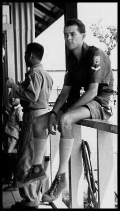 John Knowles sits on the veranda rail of the MRC